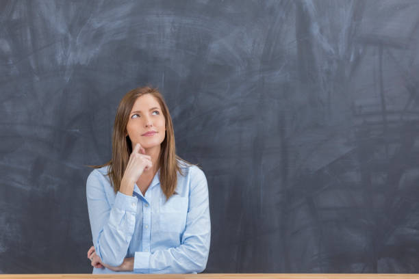 Portrait of middle age business executive woman in thought, thinking brainstorming in studio