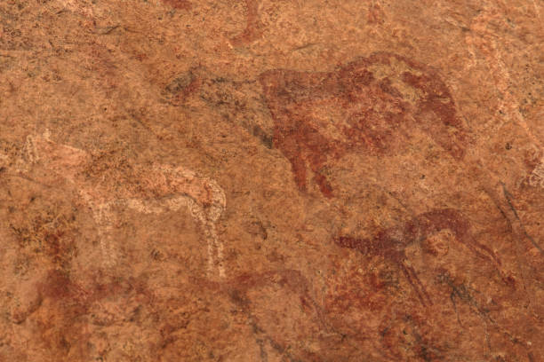 istock Ancient rock paintings African mountains ion a beige background 643431944