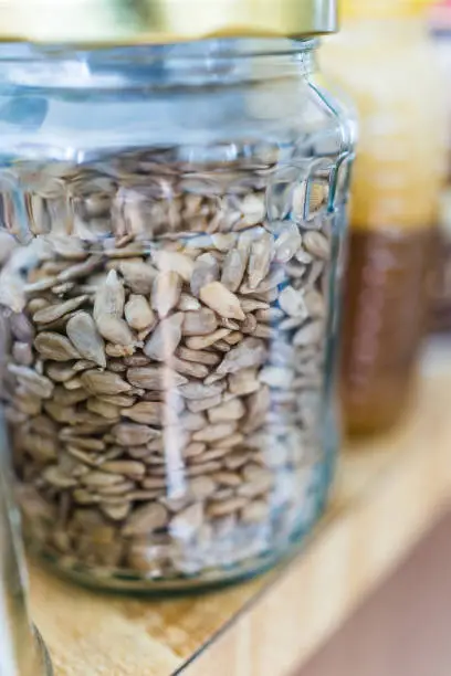 Macro closeup of raw sunflower seeds in jar