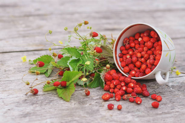 istock Strawberry in a cup on a wooden surface. 643436456