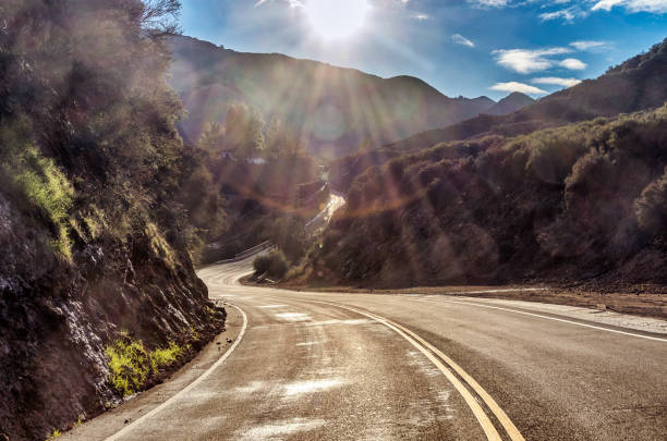 sun shines over famous mulholland highway in california - road highway winding road mountain imagens e fotografias de stock