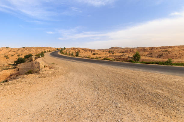istock Road at Sahara desert in the afternoon. 643439514