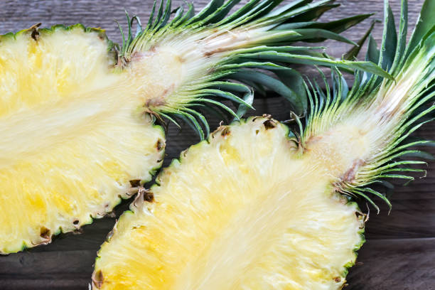 istock Pineapple on the wooden background: cross section 643442822