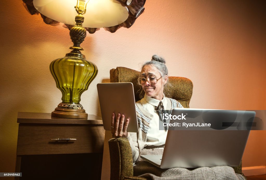 Grandma Using Tech Grandma Using Multiple Modern Electronics Stock Photo - Download Image ...