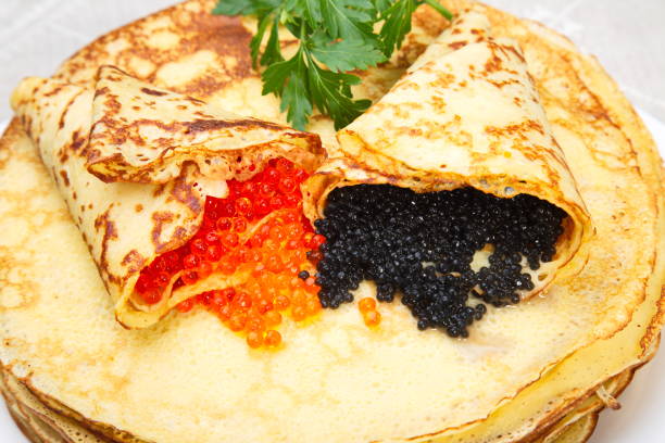 istock Pancakes with red and black caviar. 643446396