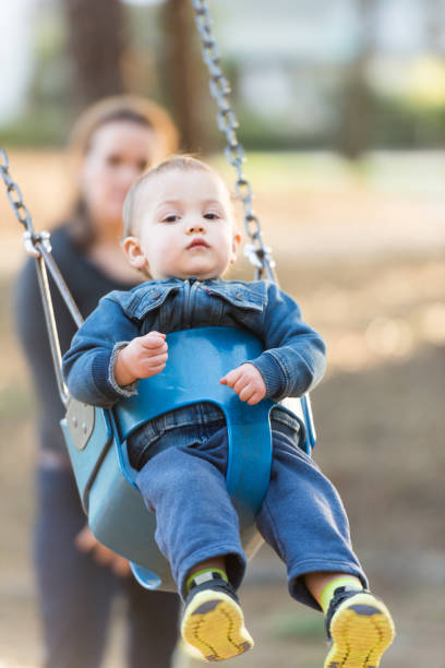 istock Mother and baby having fun in a park 643446650