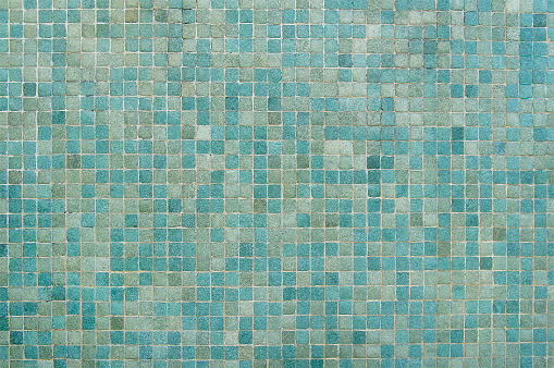 Blue and green mosaic wall background texture close up