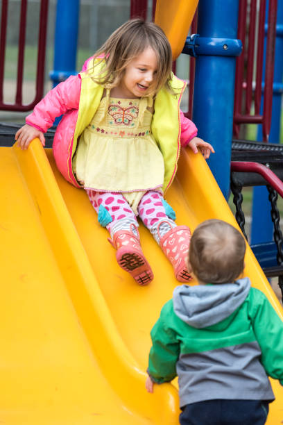 istock children playing at a playground 643460744