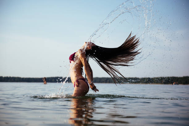 istock blonde woman on water background 643469490