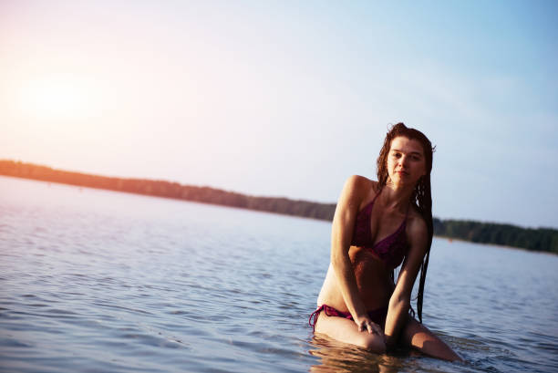 istock Young beautiful girl posing on the beach 643469624