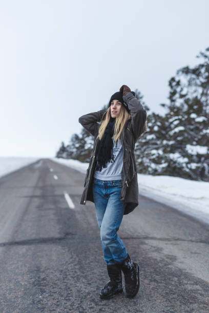 istock Girl is standing on the winter road 643469850