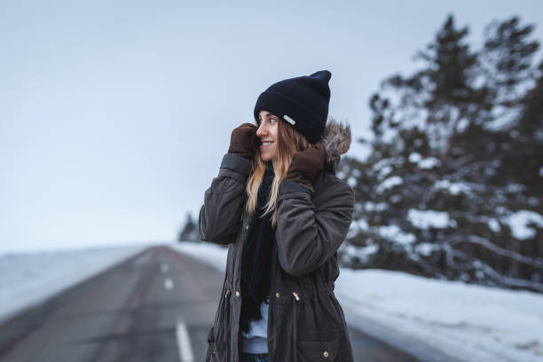 istock Girl is standing on the winter road 643469892