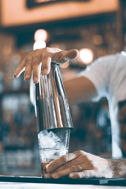 istock Expert barman making cocktail at night club cocktail shaker. 643480266