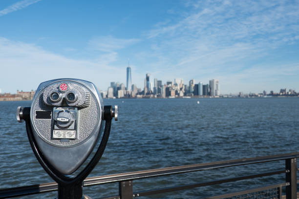istock Tower viewer telescope looking at lower Manhattan skyline from Liberty Island. Railing and binoculars on a stand for tourists to view New York City from across the New York Harbor. 643480594