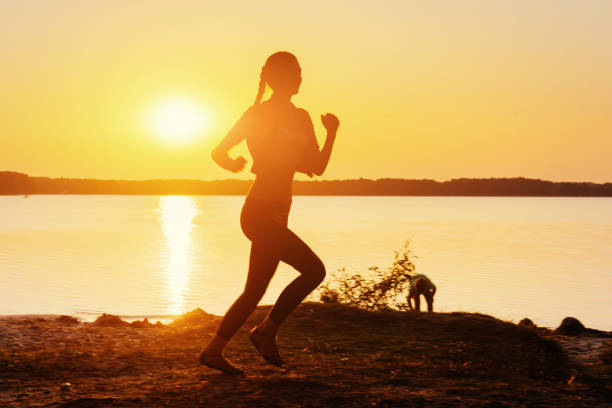 istock girl at sunset by the lake 643484286