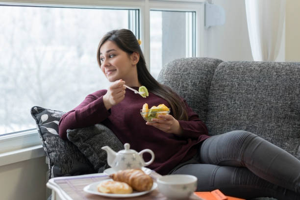 istock Young woman having a breakfast at home 643488048