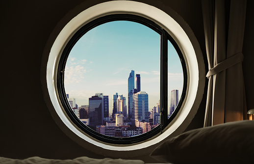 Circle windows with modern buildings in the city at morning