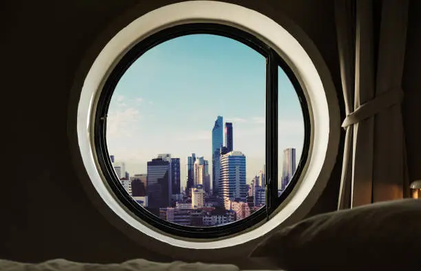 Photo of Circle windows with modern buildings in the city at morning