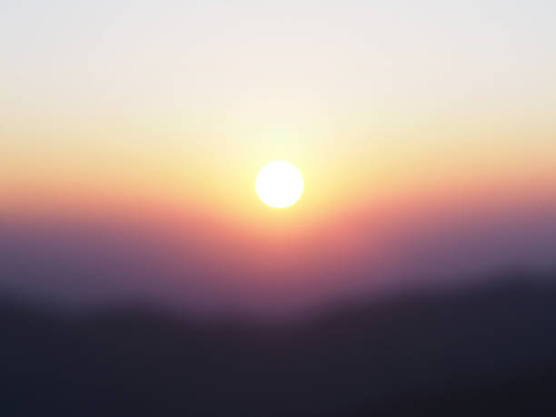 istock Sun at sunrise with blurry mountain and sky background 643513436