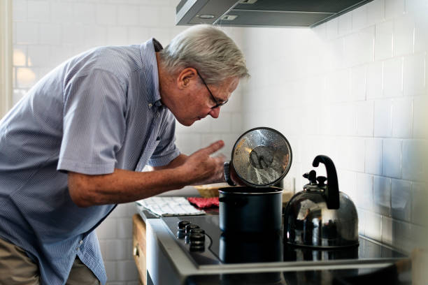 istock Senior Man Cooking Food Kitchen 643521164