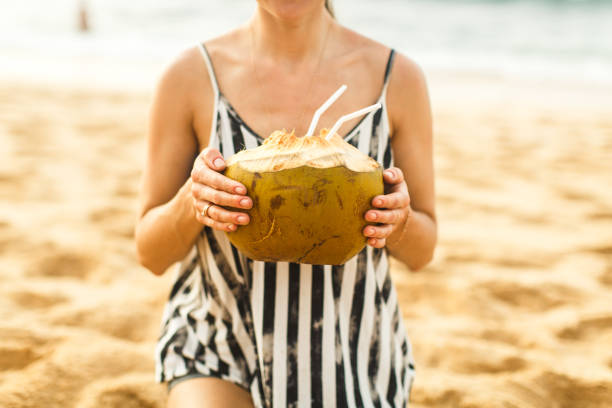 istock girl holds coconut in hand 643522528