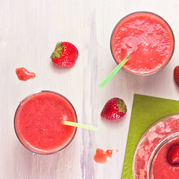 istock Strawberry smoothies with fresh berries scattered around 643529782