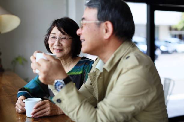 An old couple talking happily in a cafe