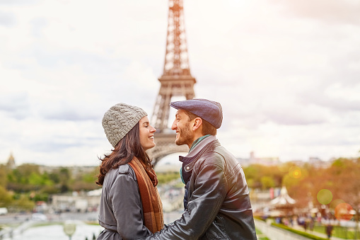 Shot of a happy young couple kissing together in front of the Eiffel Tower