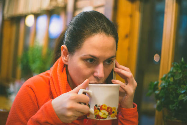 istock beautiful young woman drinking tea 643540260