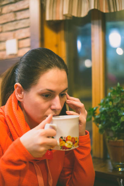 istock beautiful young woman drinking tea 643540354