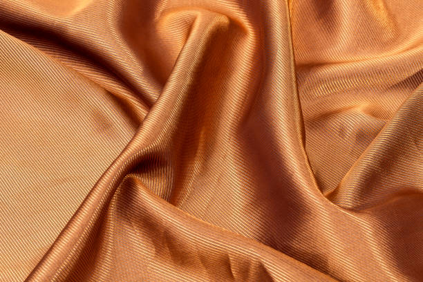 istock Silk background, texture of gold color shiny fabric 643543706