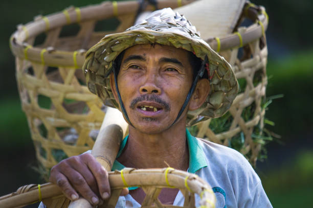 istock Balinese rice farmer with baskets. 643544570