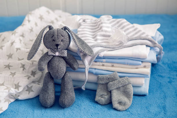 istock baby clothes with diapers are stacked 643554360