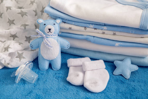 baby clothes with diapers are stacked