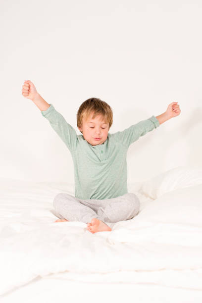 istock A boy lies on a bed and stretches 643557436