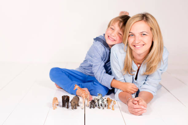 istock young, pretty mother and boy with toys animals 643557544