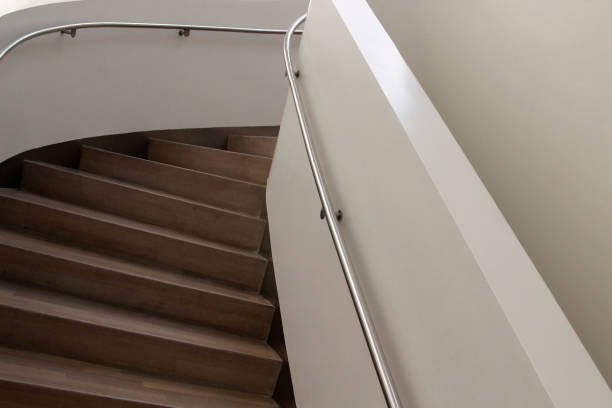 istock Staircase hall with metal handrails and light brown stairs 643560002