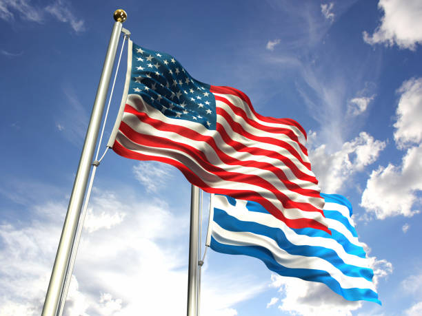 istock American and Greece flags waving against the sky 643564214