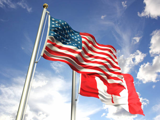 istock American and Canada flags waving against the sky 643564548