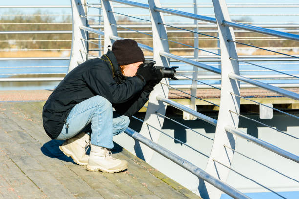 Photographer taking picture through railing