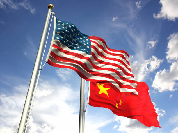 istock American and China flags waving against the sky 643570706