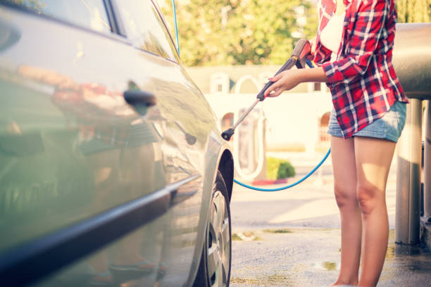 istock Young Woman Washing The Car 643575704