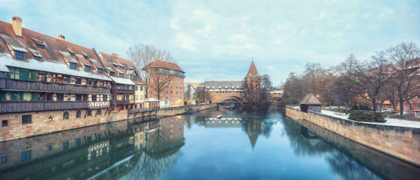 Winter landscape of fortification with a tower Fronveste Schlayerturm on Pegnitz river in Nuremberg, Bavaria, Germany