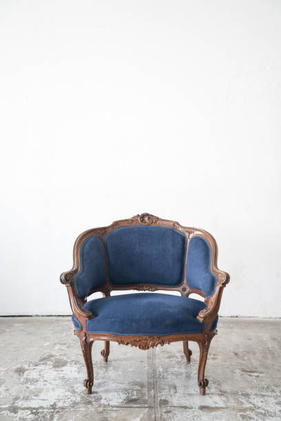 istock vintage armchair on white wall. 643582304