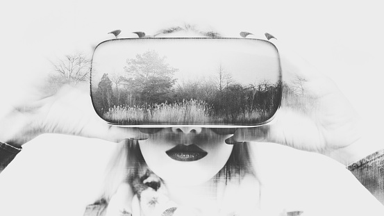Attractive woman wearing virtual reality glasses. VR headset. Doble exposure virtual reality concept.