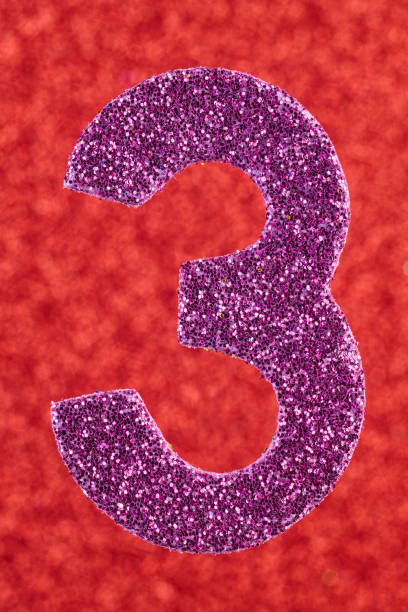 istock Number three purple color over a red background. Anniversary. 643582730
