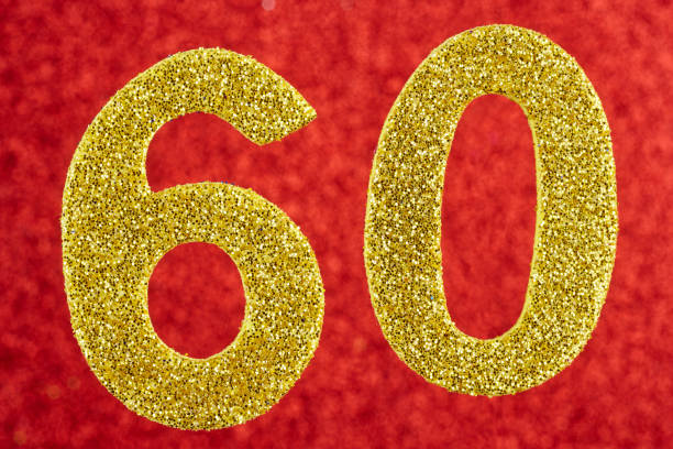 istock Number sixty yellow color over a red background. Anniversary. 643582960