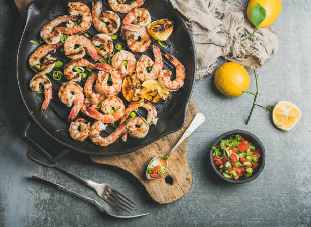 istock Grilled tiger prawns in pan with lemon, leek, chili, sauce 643584084