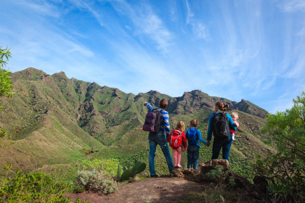 istock family with three kids hiking in mountains 643584190