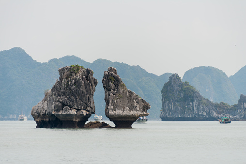 Kissing Rocks in Ha Long Bay in Vietnam. The rocks are also known as the Kissing Cocks. The bay is a UNESCO World Heritage Site inscribed in 1994 and is one of the most famous tourist attractions in Vietnam.